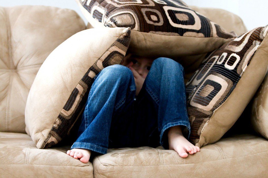 hiding beneath cushions